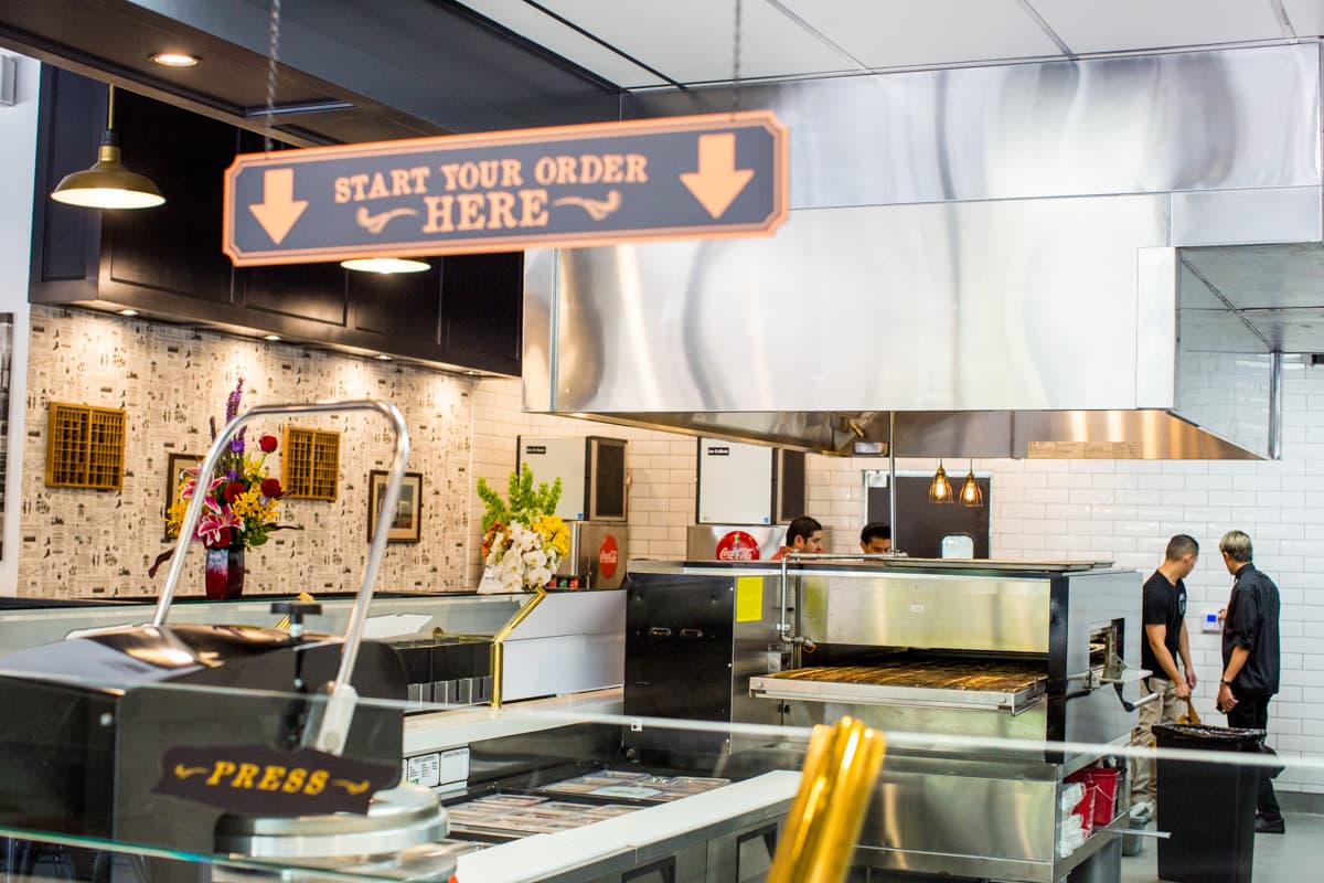 Order counter with a 'Start your order here' sign above the pizza line